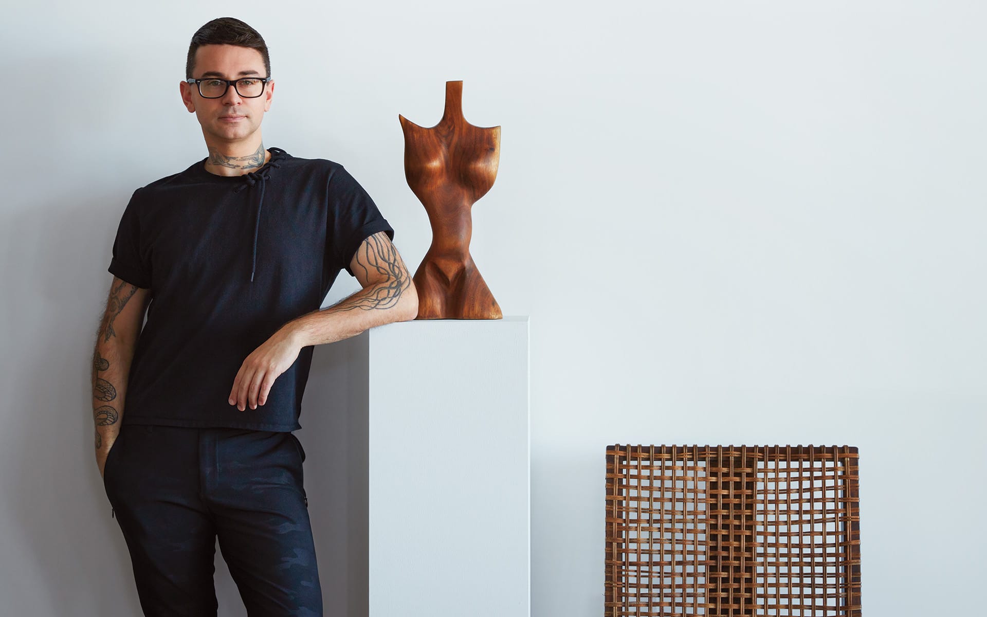 Designer Christian Siriano with a sculpture by an unknown artist.