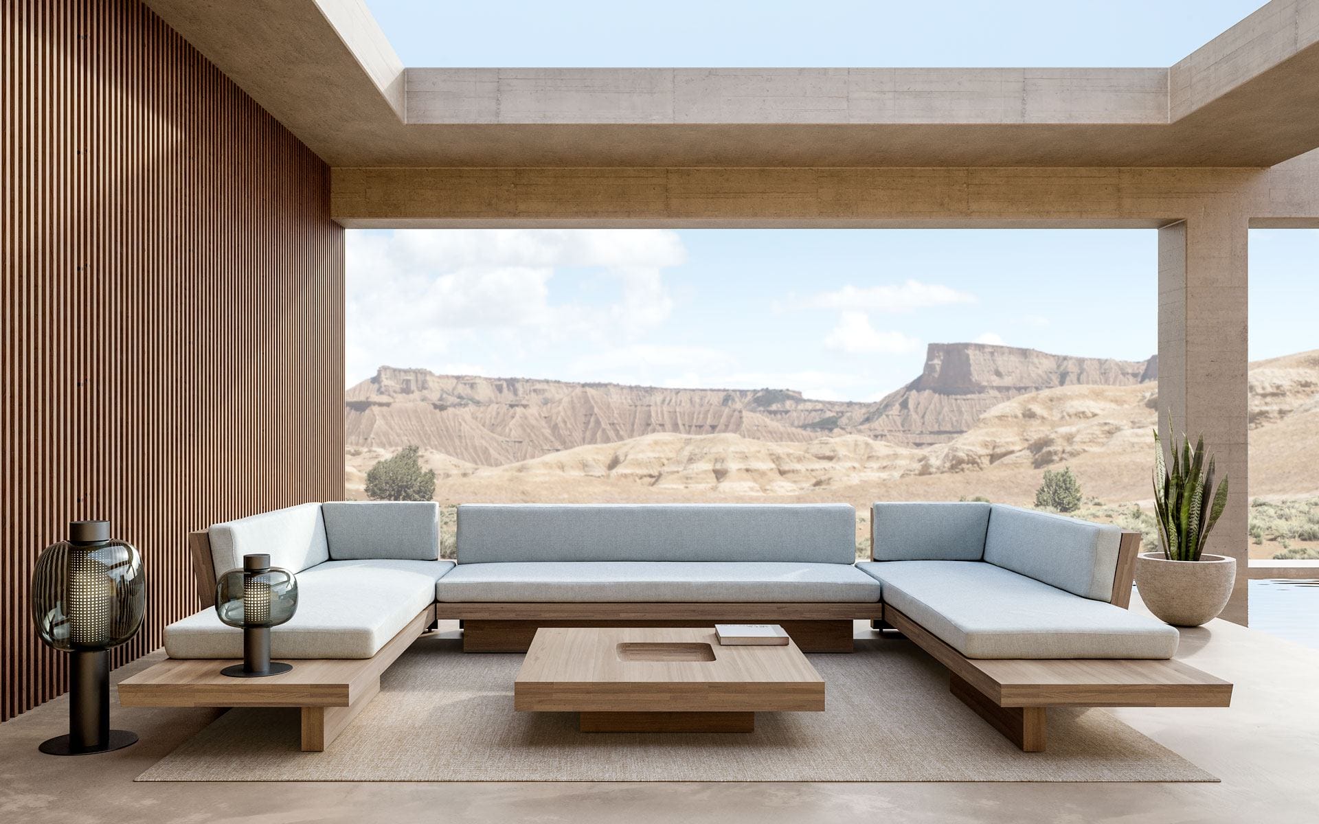 Modern outdoor patio with minimalist furniture and desert mountain view.