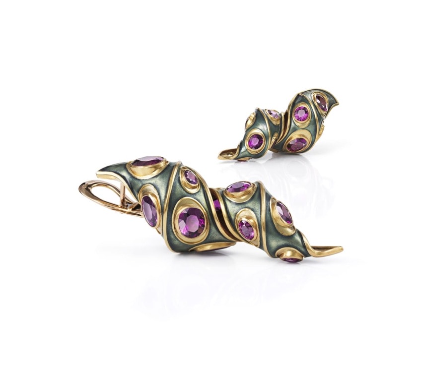 Gold and black embellished jewelry set with purple gemstones, featuring a pair of elegant earrings and a matching statement ring.