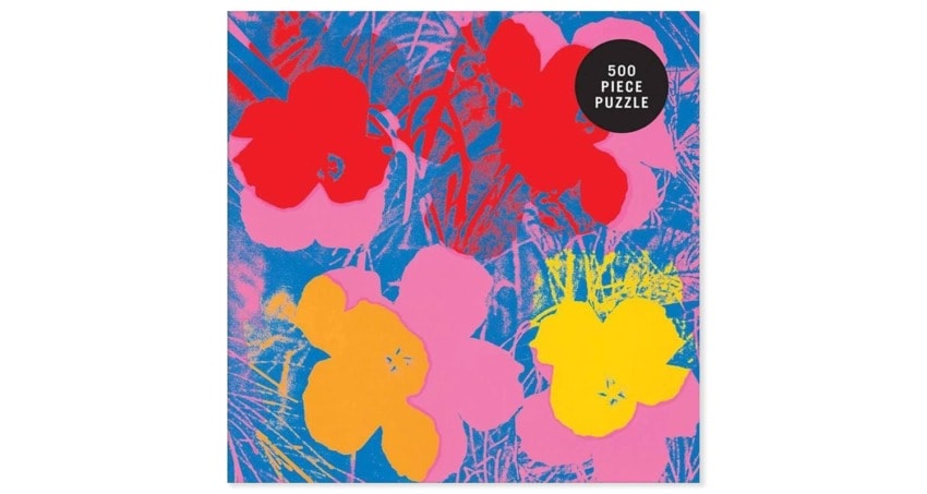 Colorful 500-piece puzzle featuring vibrant flowers in red, pink, and yellow on a blue background.