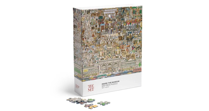 Puzzle box featuring an intricate museum collage with 500 pieces arranged in front of it.