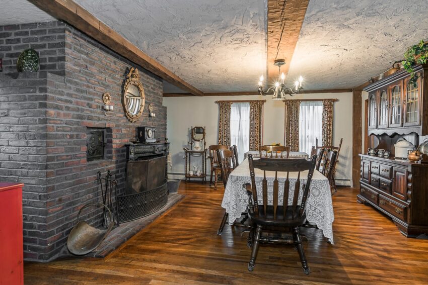 rustic dining room with brick fireplace wooden furniture and chandelier cozy vintage ambiance