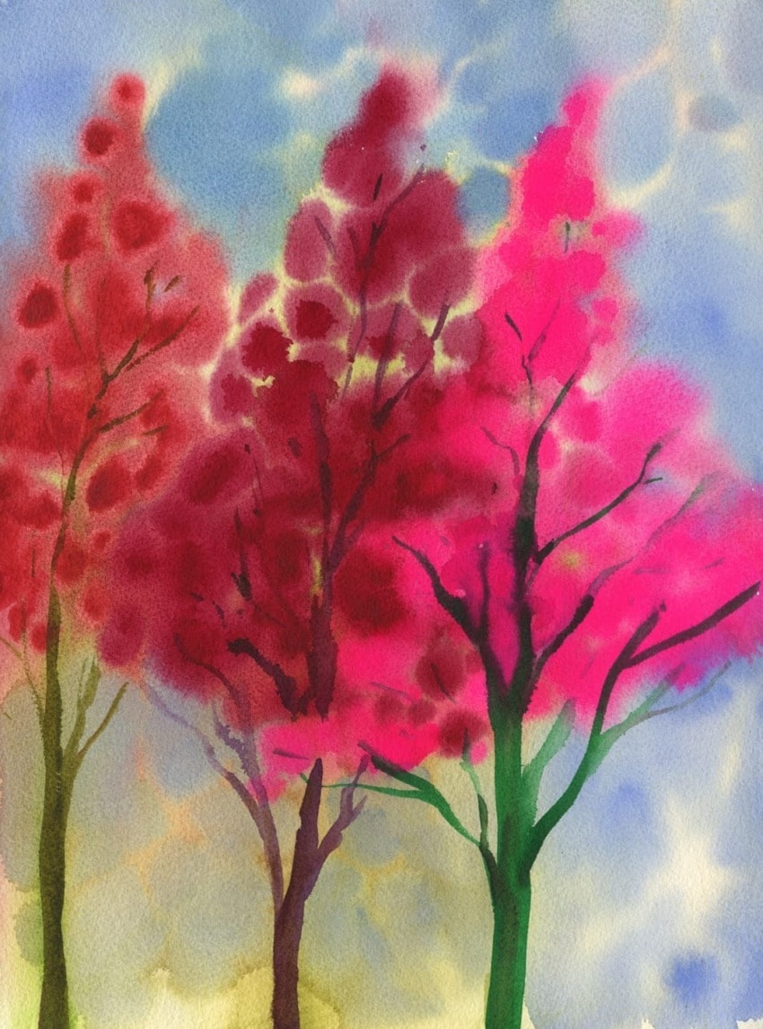 Watercolor painting of three vibrant trees with lush pink and red foliage against a blue and yellow sky.
