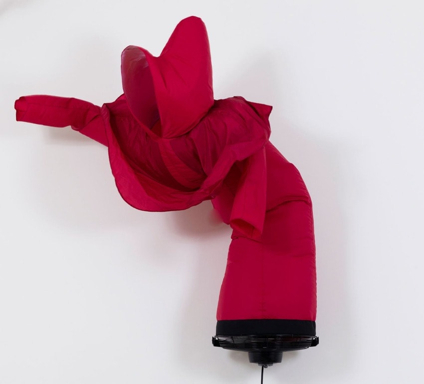 Red inflatable tube man flailing with fan base against a plain white background.