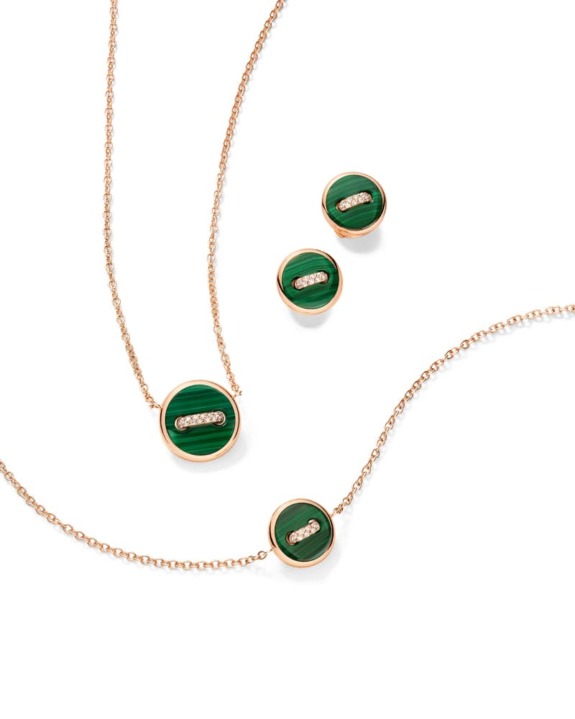 Gold jewelry set with green malachite stones and diamond accents, including necklaces and earrings, on a white background.