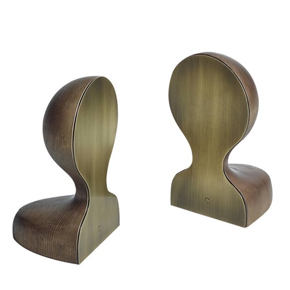 Two modern, abstract bronze-colored sculptures with a smooth, curved design placed side by side on a white background.