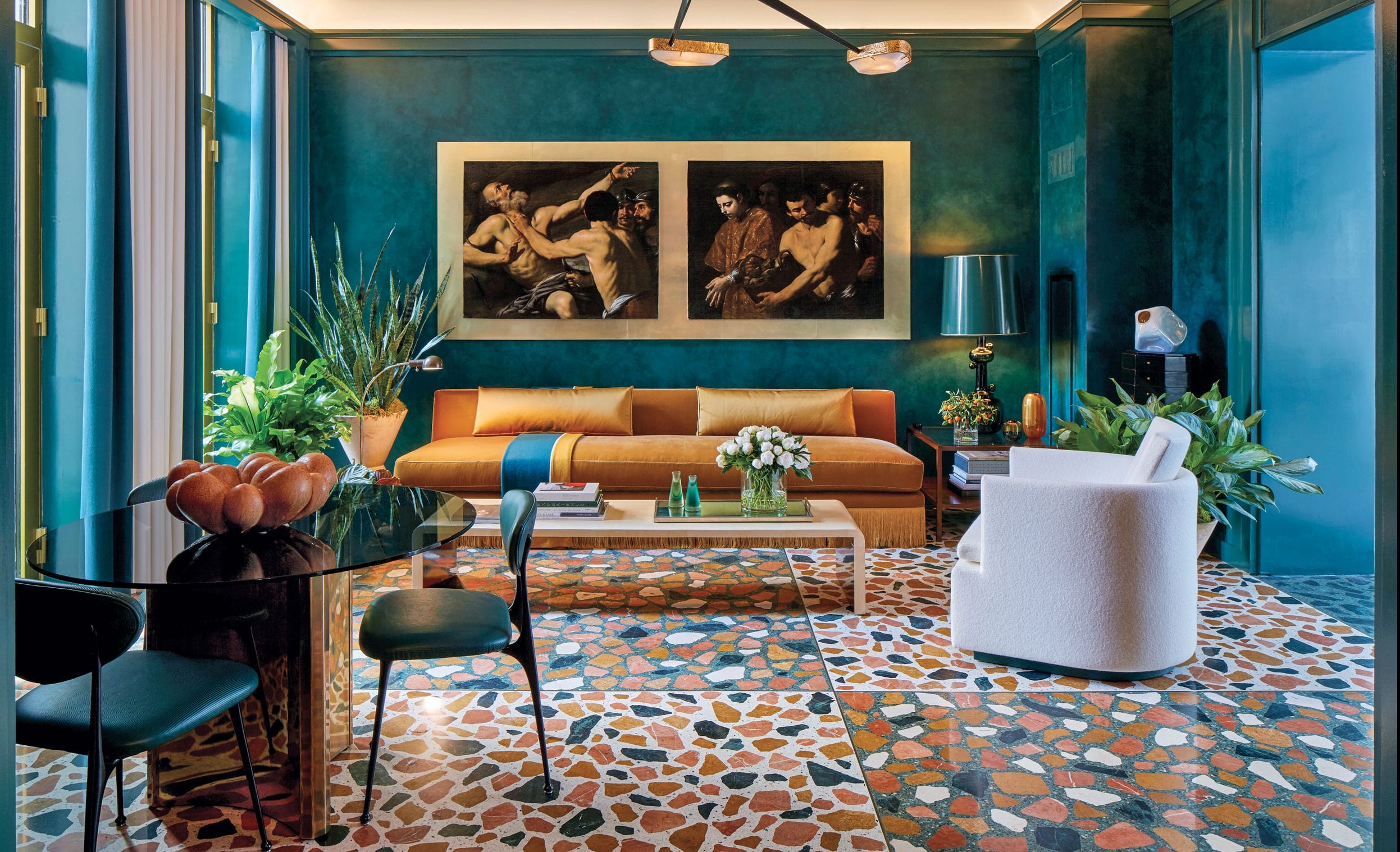 Stylish living room with vibrant teal walls, modern furniture, abstract art, and lush green plants.