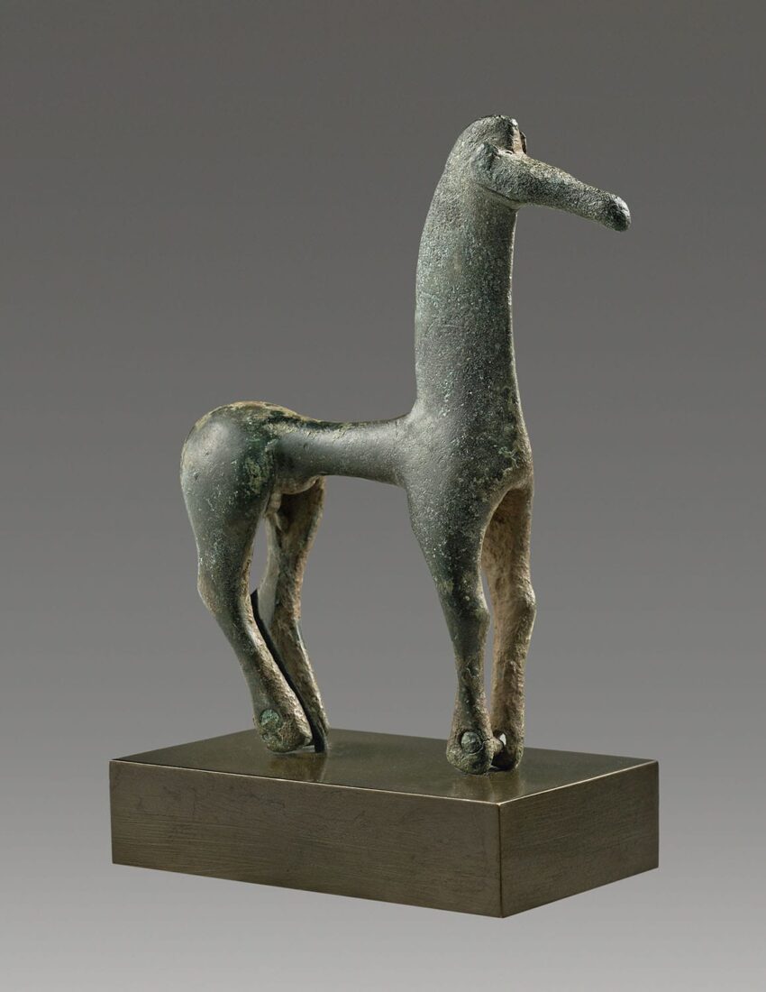 Ancient Greek bronze horse sculpture with elongated neck and smooth green patina, displayed on a rectangular base.