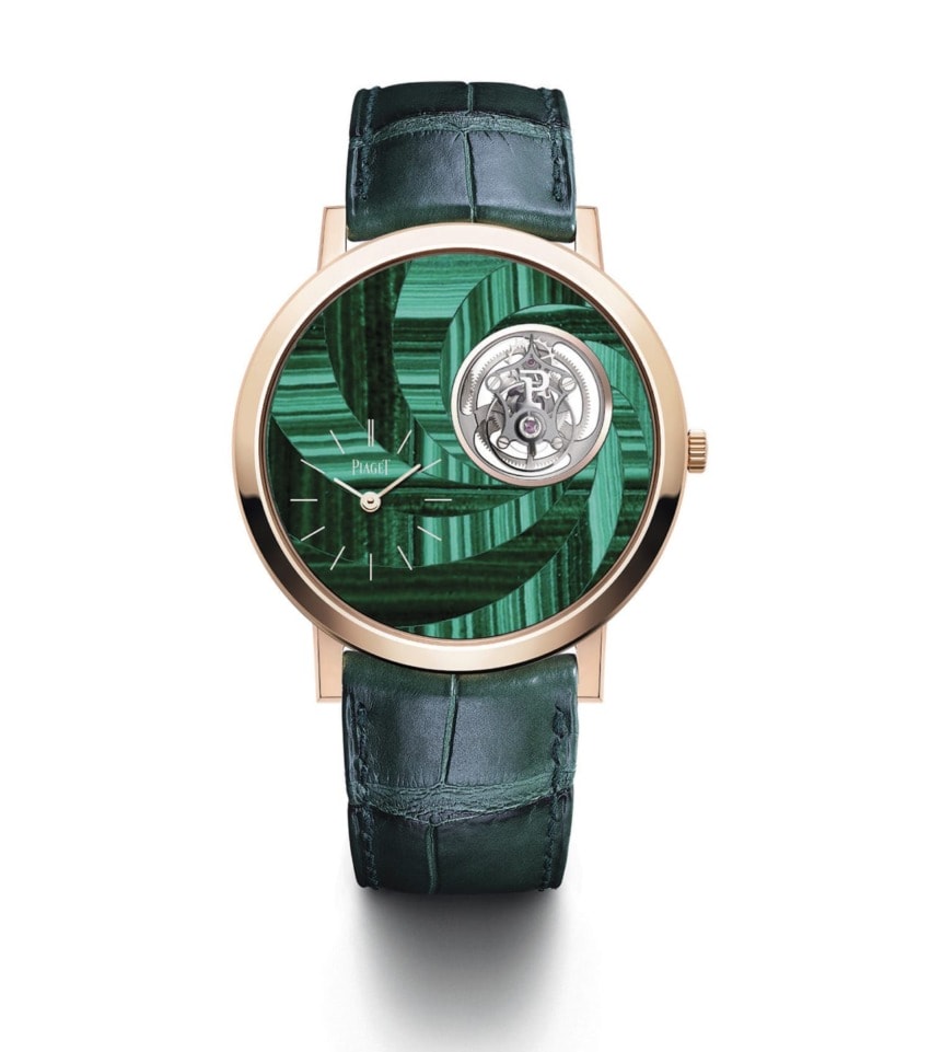 Luxury watch with a green malachite dial, intricate mechanism, gold casing, and green leather strap.