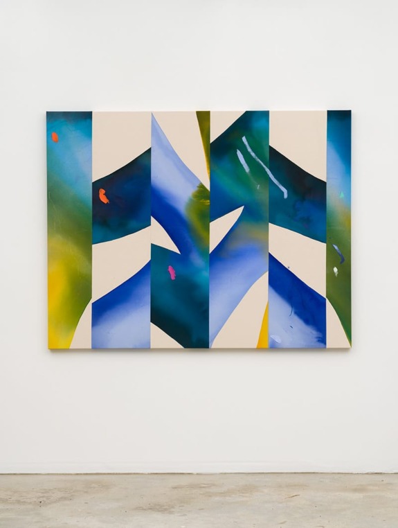 Abstract painting with vibrant blue, green, and yellow geometric patterns on a canvas against a white wall.