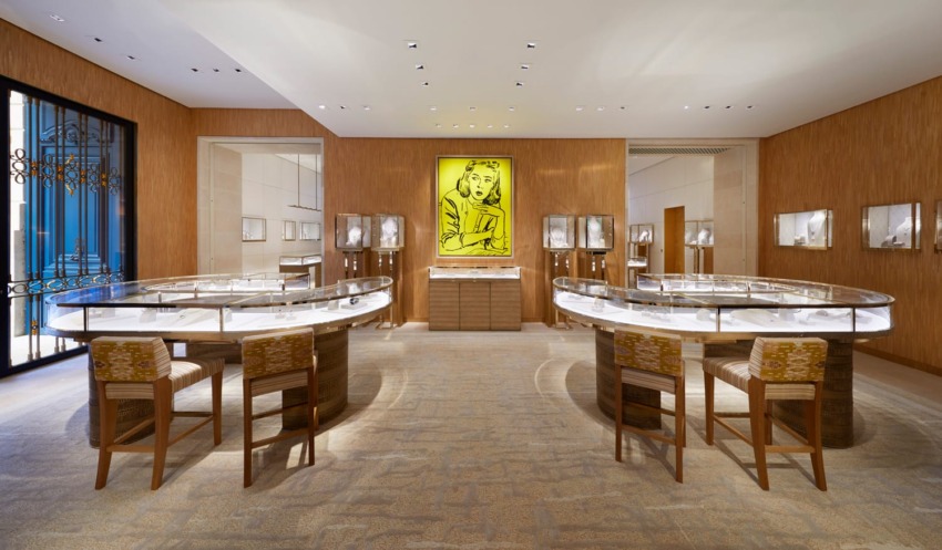 Luxurious jewelry store interior with elegant display cases, modern lighting, and artwork on the wall.