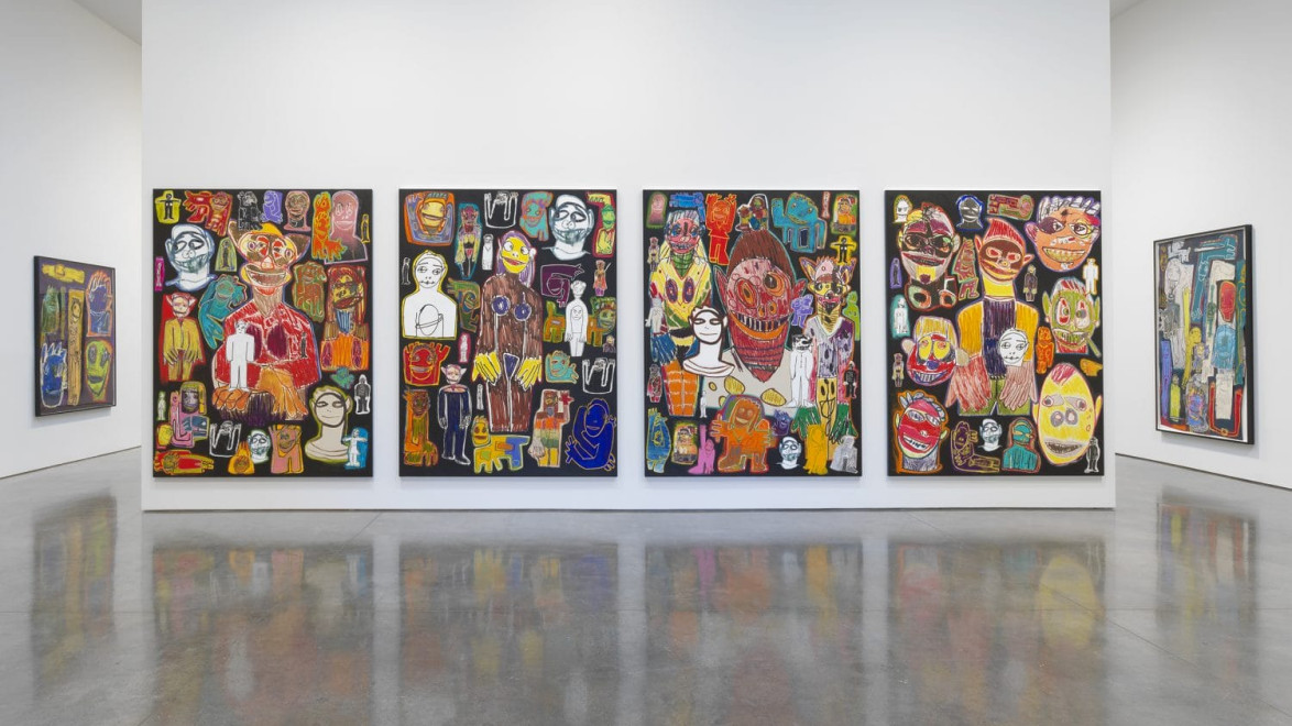 Colorful abstract art gallery display with five large canvases featuring vivid, expressive faces and figures in a modern setting.