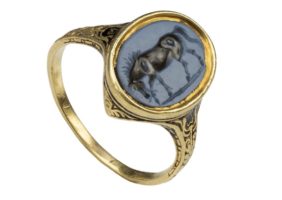 Gold ring with an engraved stone featuring an ancient rabbit design.