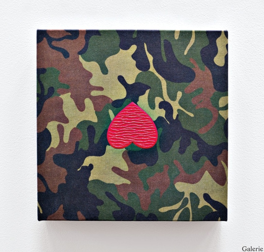 Camouflage pattern square canvas with a prominent red heart shape in the center.