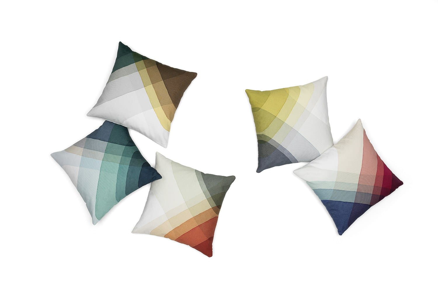 Five colorful geometric patterned throw pillows arranged on a white background.