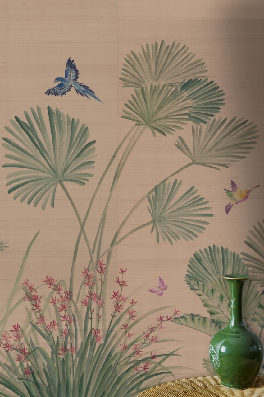 Green vase with palm leaves and colorful birds on a beige background.