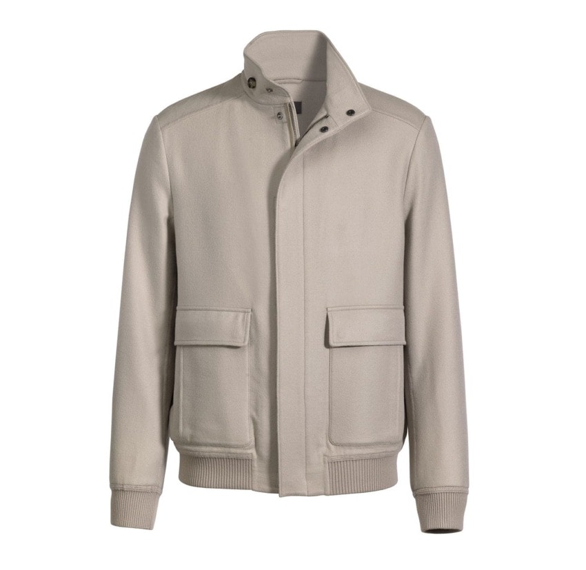 Beige men's jacket with front pockets and ribbed cuffs, displayed on a white background.