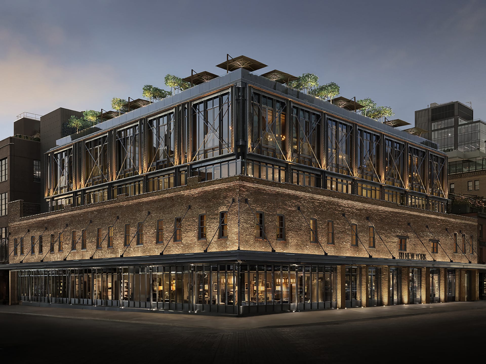 Modern multi-story brick building with large windows, rooftop garden, and evening lighting on a city street corner.