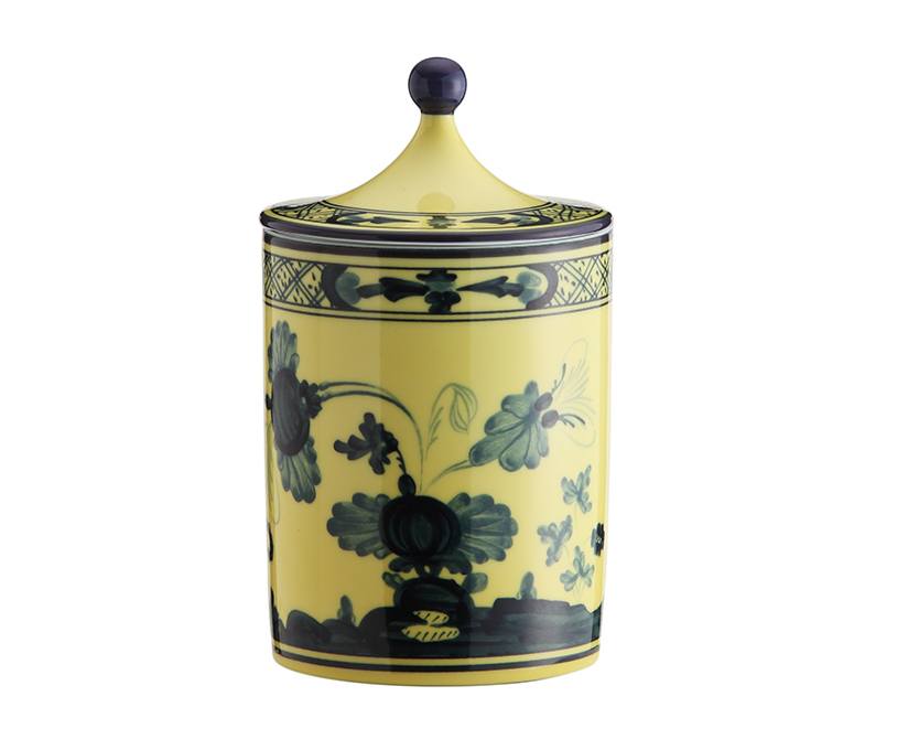 Yellow ceramic jar with blue floral patterns and a lid.