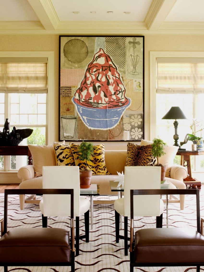 Elegant living room with modern art, patterned rug, and stylish furniture arrangement.