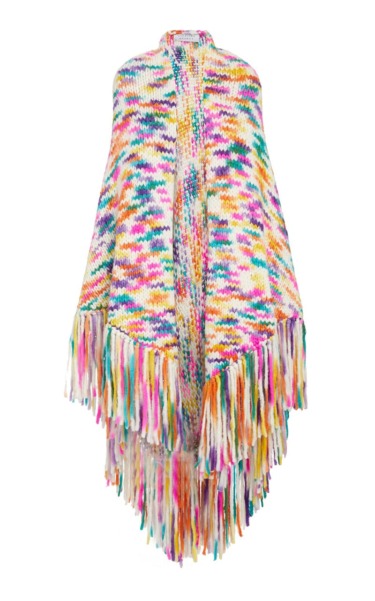 Colorful knitted poncho with vibrant multicolored fringe, featuring a pattern of assorted bright hues on a white background.