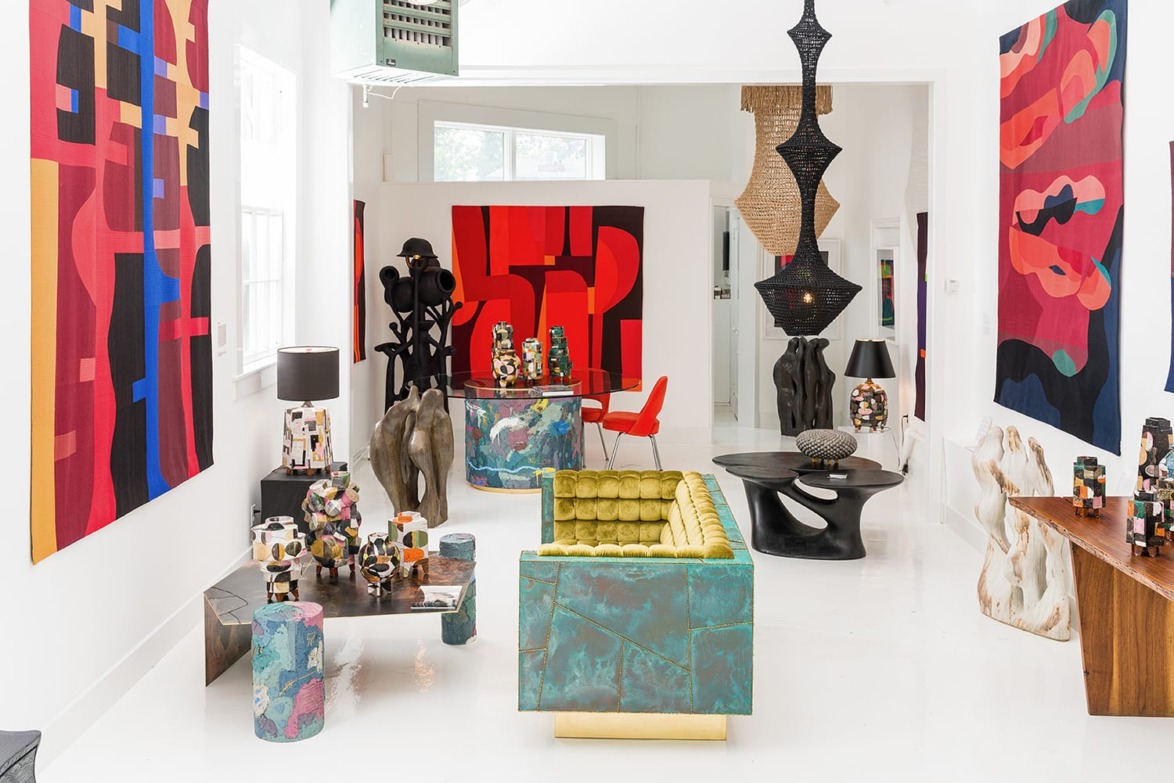 Colorful modern art gallery interior with abstract paintings, eclectic sculptures, and unique furniture pieces.