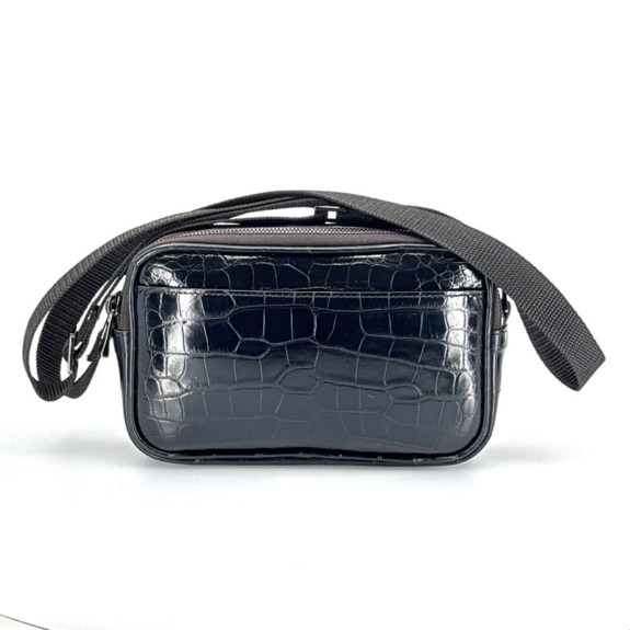 Black leather crossbody bag with crocodile pattern and adjustable strap.