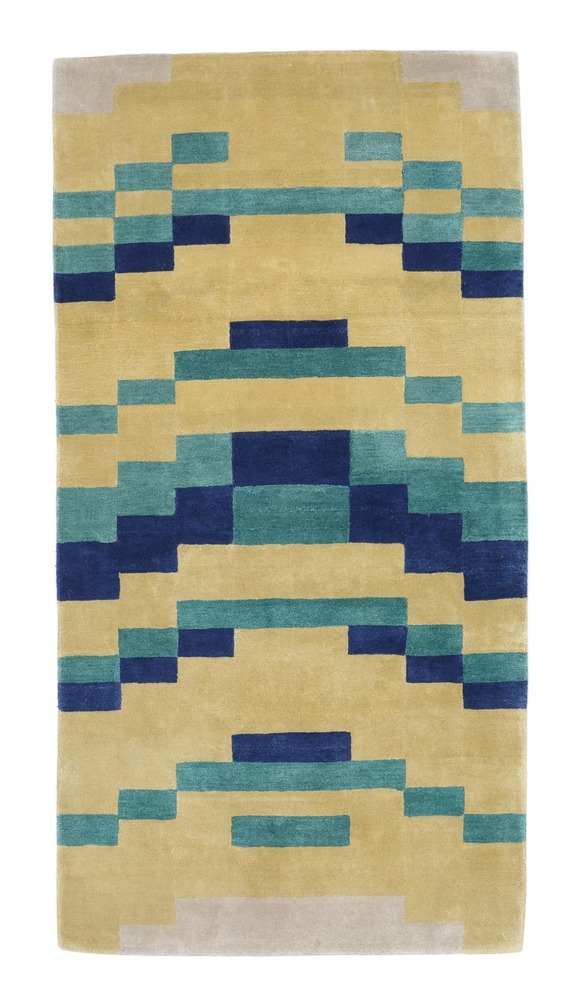 Geometric patterned rug with shades of blue, teal, and yellow.