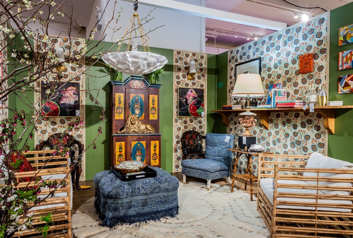 Eclectic room with patterned wallpaper, colorful furniture, and decorative elements in a cozy setting.