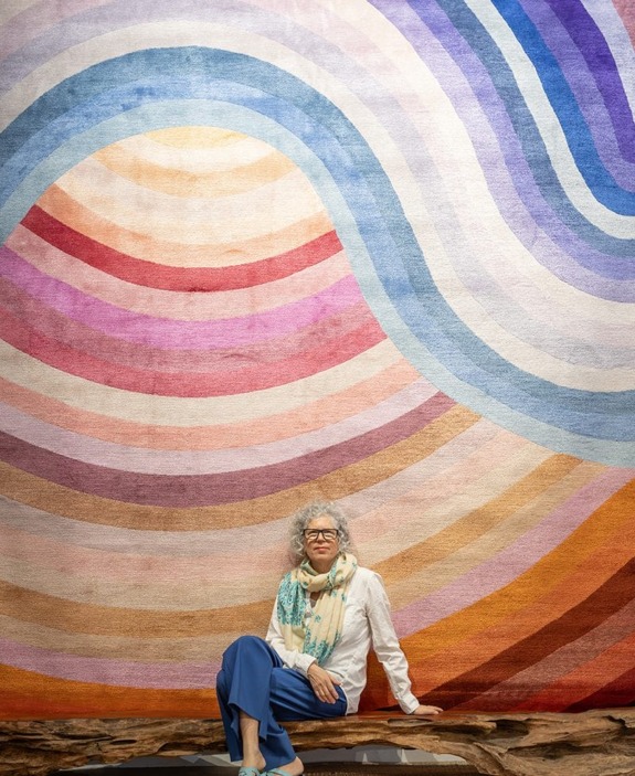 Artist Michelle Weinberg with one of the rugs she designed for Carini.