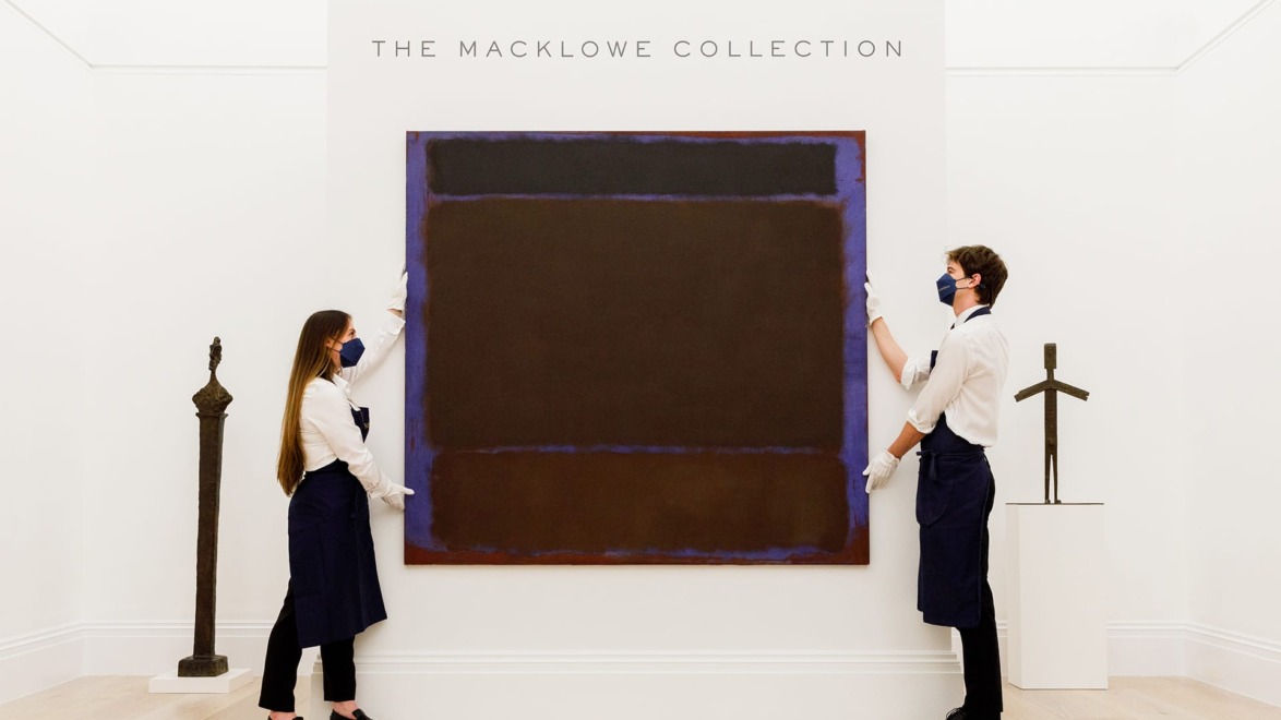 Two museum staff members display a large abstract painting from The Macklowe Collection.