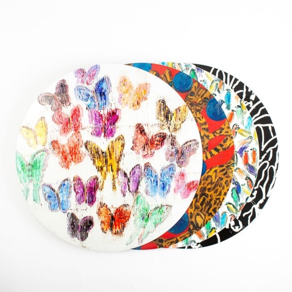 Colorful round artworks with butterfly designs layered over each other on a white background.