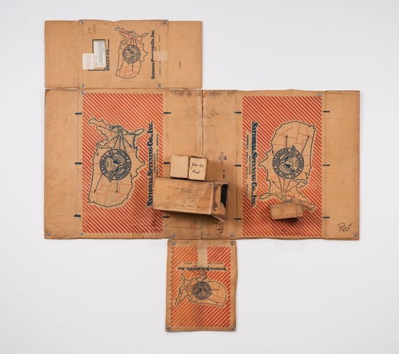 Reconstructed cardboard box art with detailed red and brown graphics, featuring a map and vintage design elements.