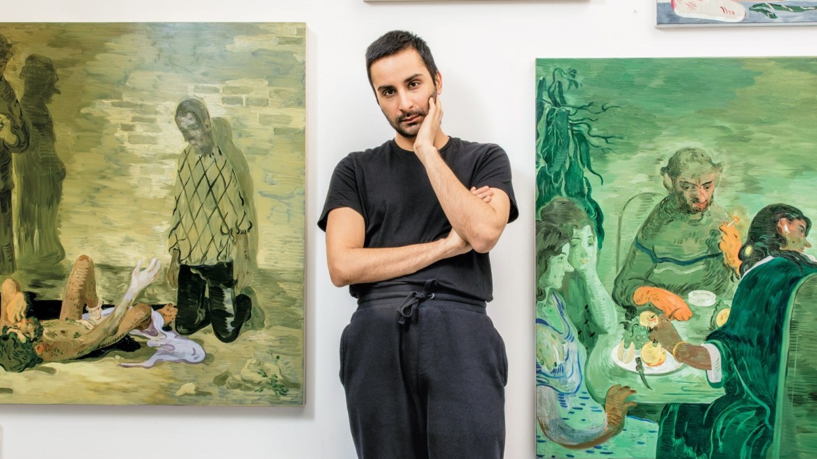 Person standing between two paintings in an art gallery.