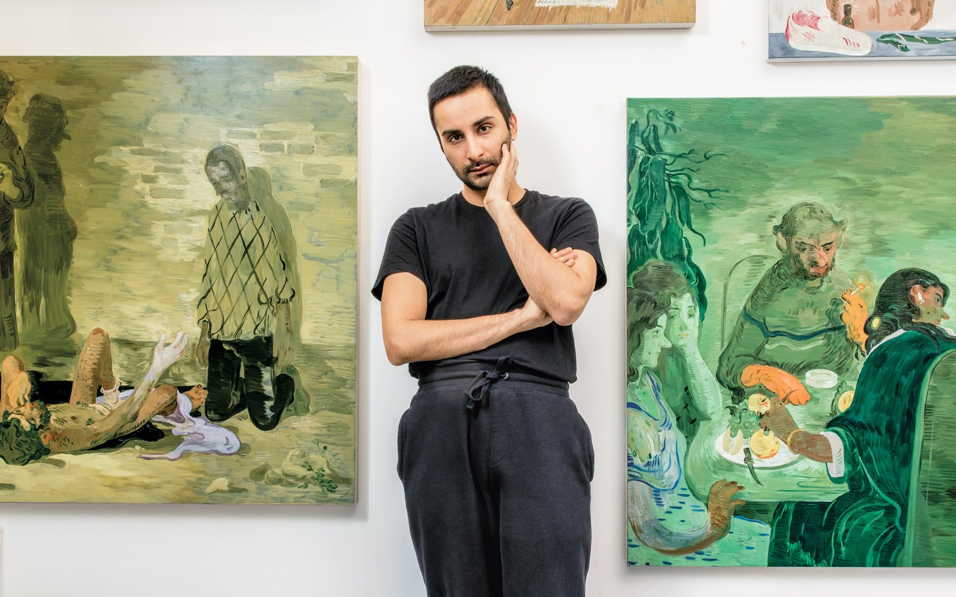 Person standing between two paintings in an art gallery.