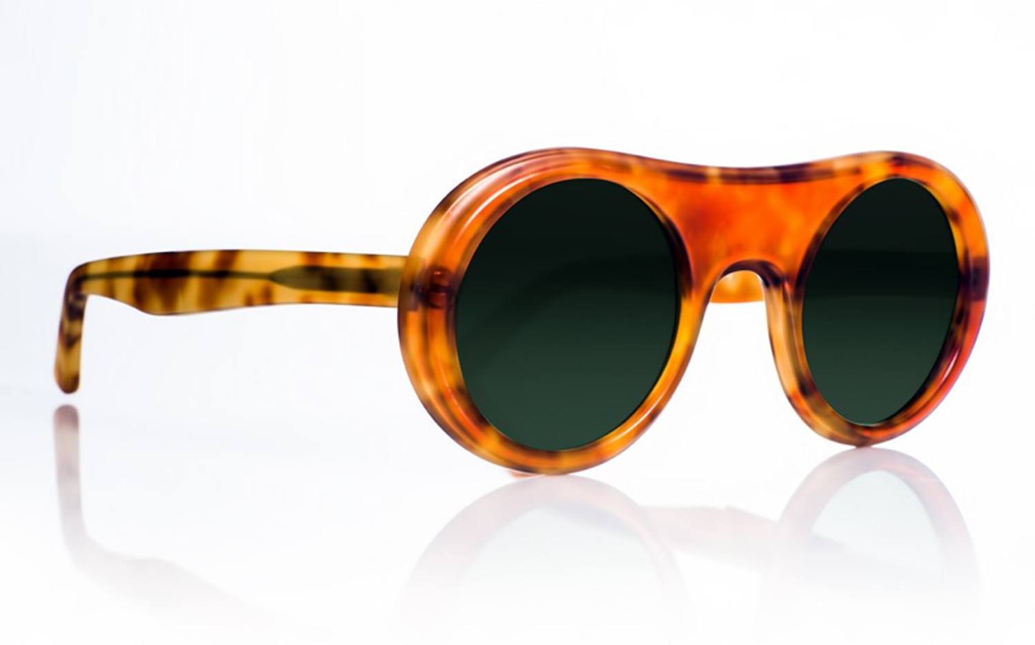 Tortoiseshell round sunglasses with dark lenses on a white background.