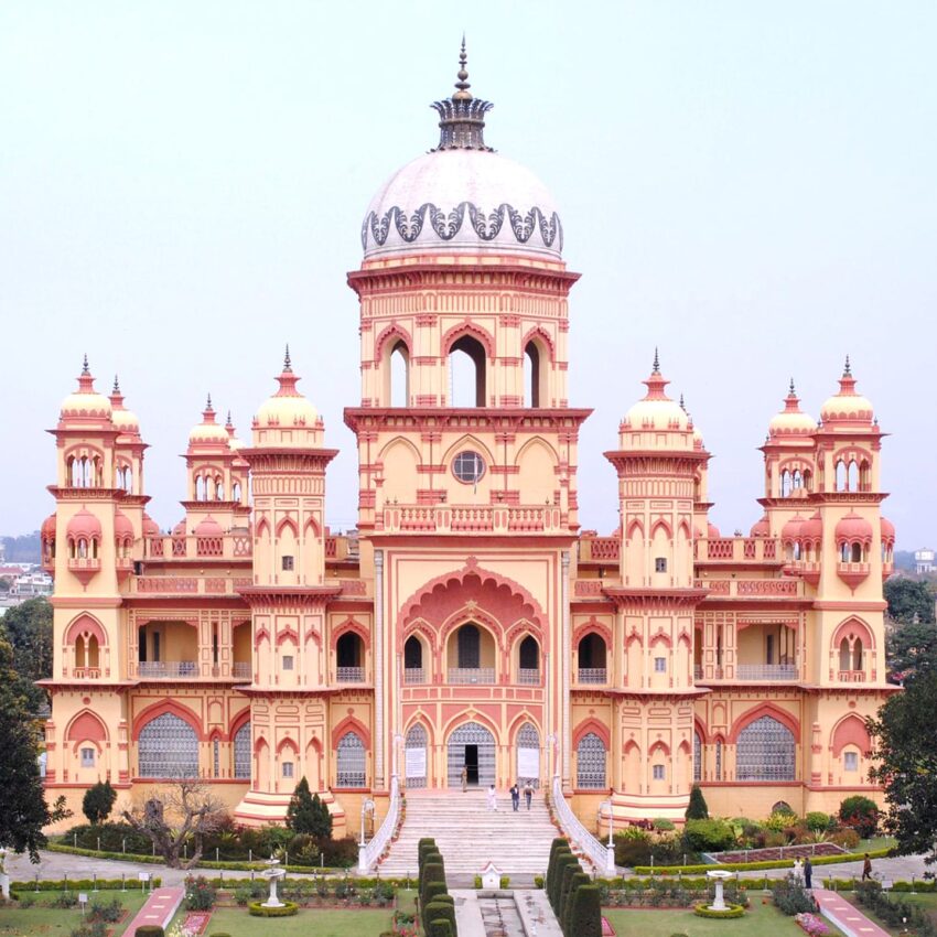 Historic palace with stunning architecture, featuring a central dome and multiple towers against a clear sky background.