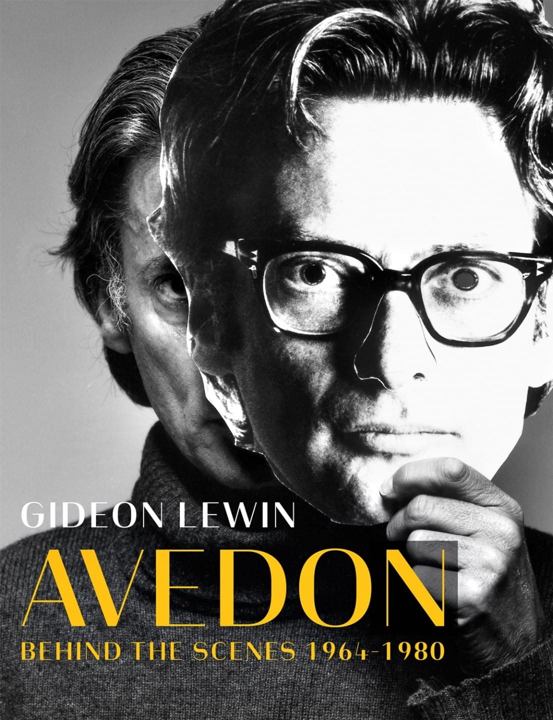 Man holding up a large black and white mask in front of his face with text "Gideon Lewin Avedon Behind the Scenes 1964-1980".