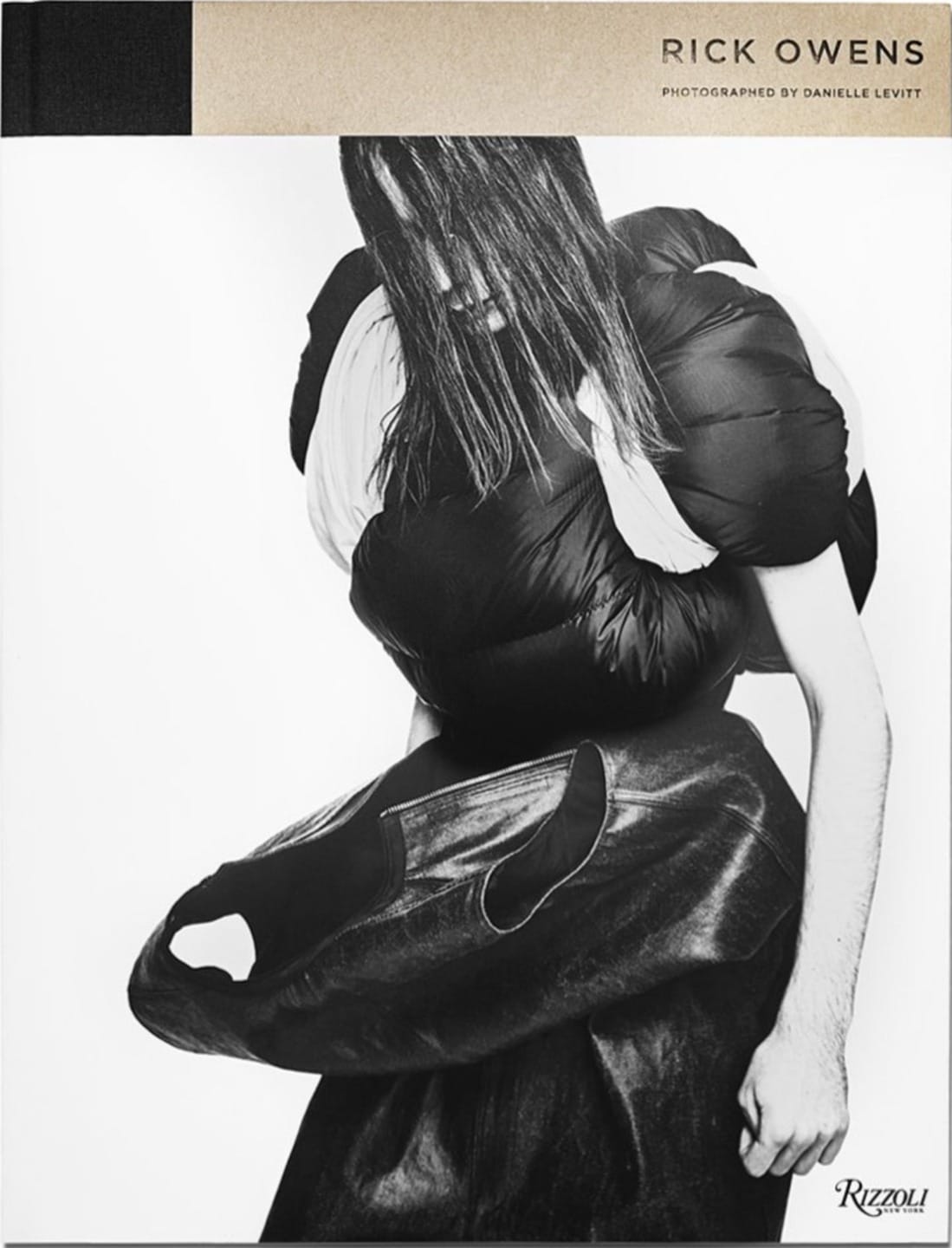 Avant-garde fashion by Rick Owens, model wearing a sculptural black dress with dark long hair, photographed by Danielle Levitt.