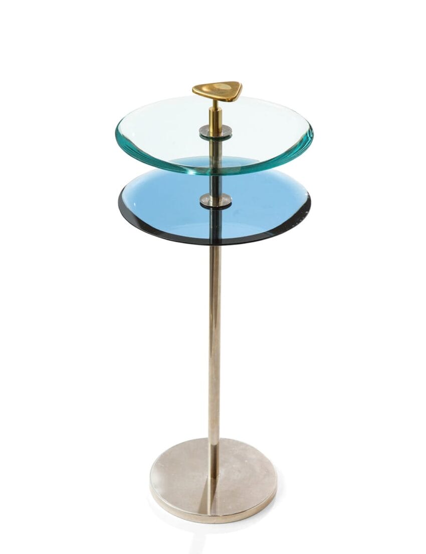 Modern glass and metal side table with two circular shelves and a golden accent handle on top.