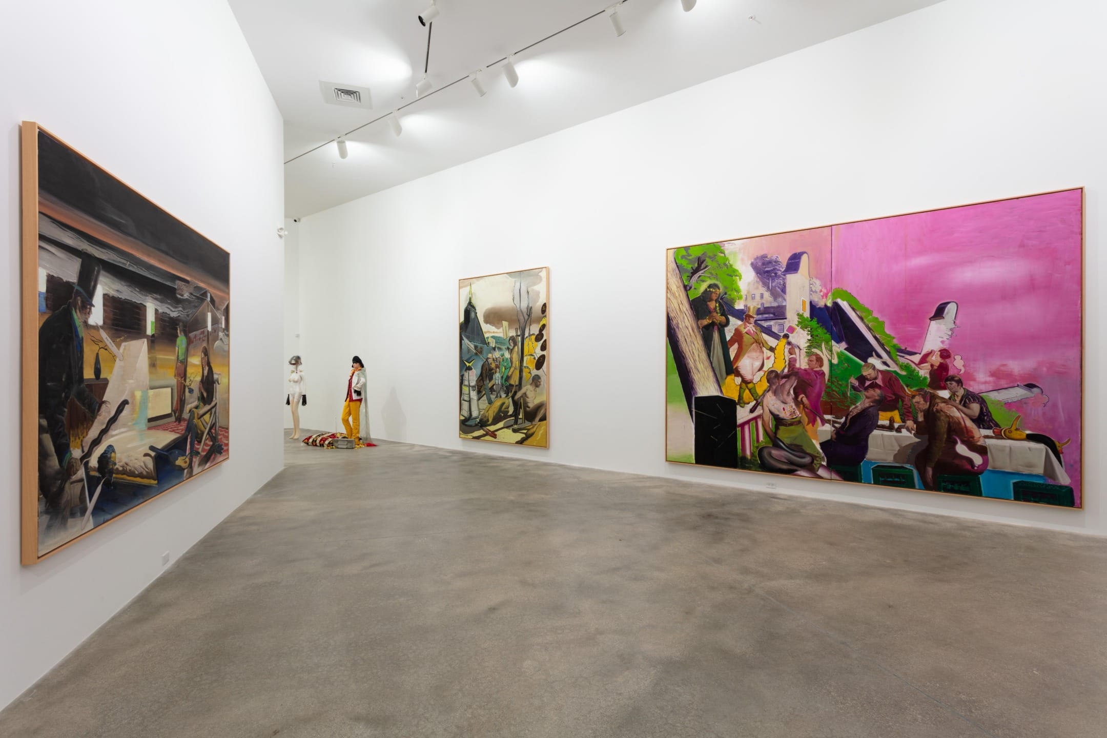 Gallery exhibiting large colorful abstract paintings on white walls with spotlights highlighting the artwork