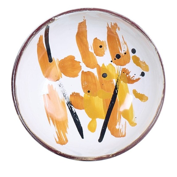 Round ceramic bowl with abstract orange, black, and brown brushstroke design on a white background.