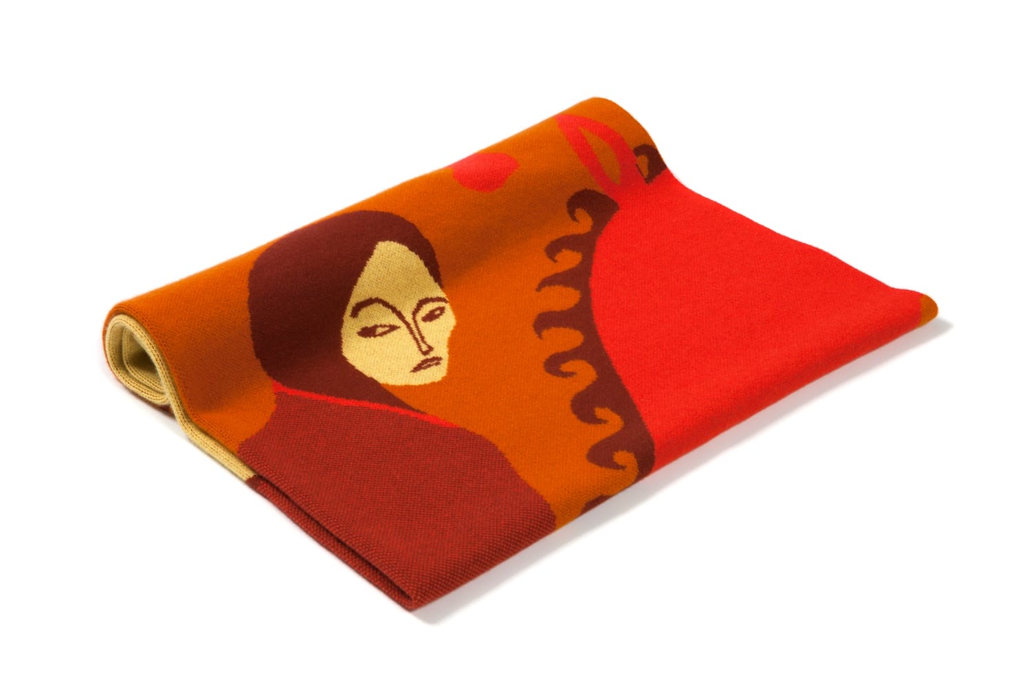 Folded vibrant scarf with abstract red and orange design featuring a face and wavy patterns, on a white background.