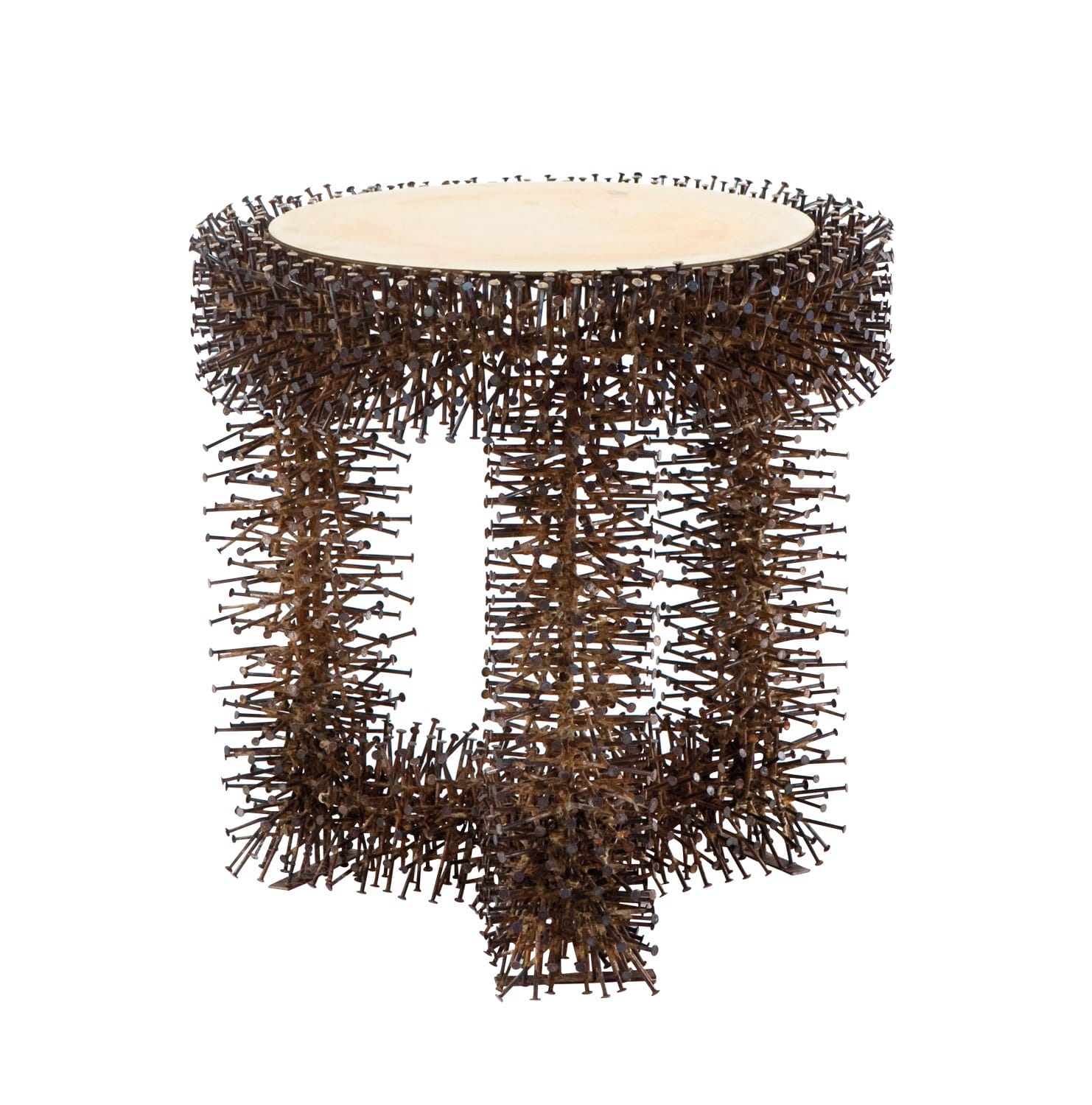 Artistic table with intricate, spiky metal frame and a smooth, circular beige top, showcasing modern design elements.