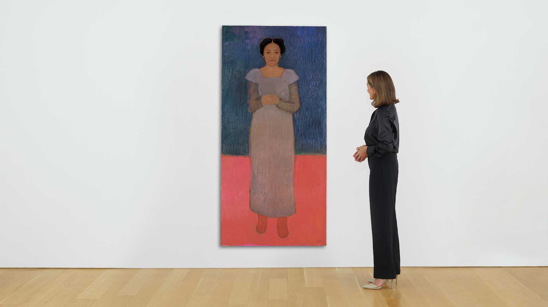Person viewing an art piece featuring a woman on a colorful background in a gallery setting.