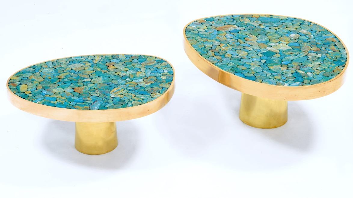 Two modern oval tables with turquoise stone tabletops and gold cylindrical bases.