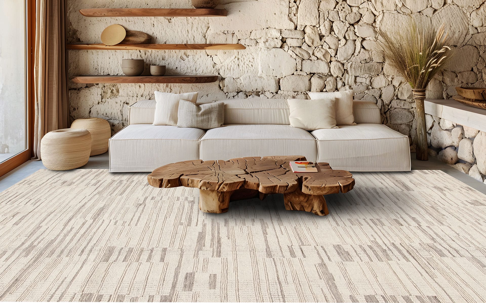 Rustic living room with a white sofa, natural wood coffee table, stone walls, and beige textured rug.