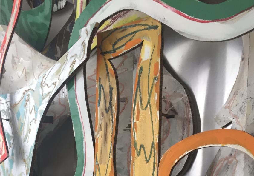 Colorful abstract metal sculpture with overlapping shapes and bold outlines.