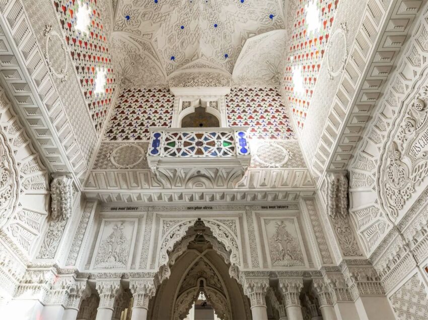 Intricately designed ornate ceiling and walls with arches in a historical architectural setting.