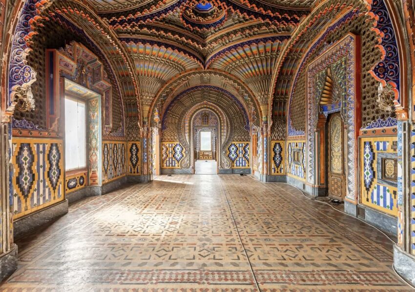 Ornate, colorful interior of an elaborate hallway with detailed arches and vibrant patterns on walls and ceilings.